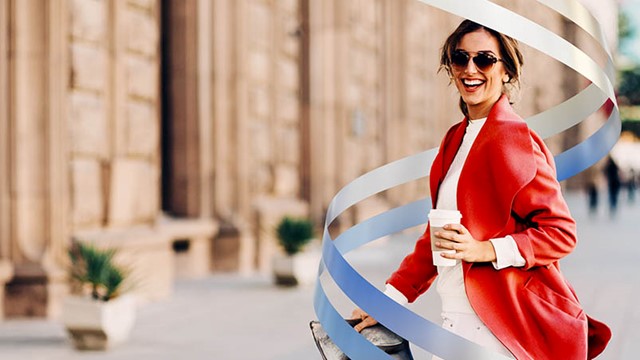 Woman in red coat holding coffee cup